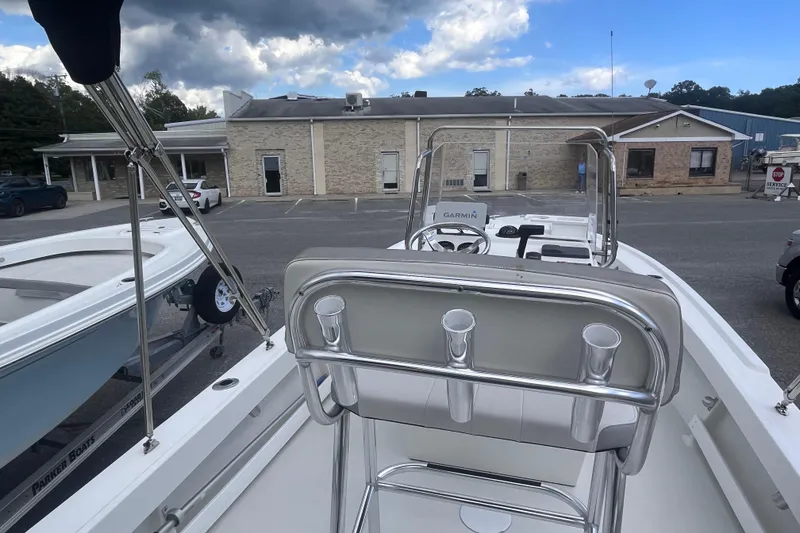 Slide: The Image of 2026 Parker 210 Coastal boat interior, featuring sleek white deck and rod holders. - 9