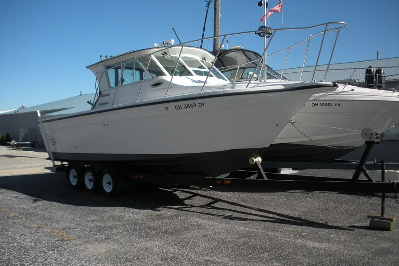 Slide: The Image of 2006 Baha Cruisers 277 GLE boat on trailer, parked outdoors. - 1