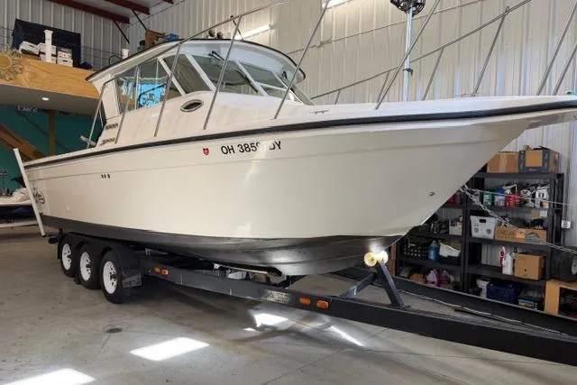 Slide: The Image of 2006 Baha Cruisers 277 GLE boat on trailer in a garage setting. - 2