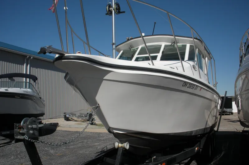 Slide: The Image of 2006 Baha Cruisers 277 GLE boat on trailer, parked outdoors under clear blue sky. - 3