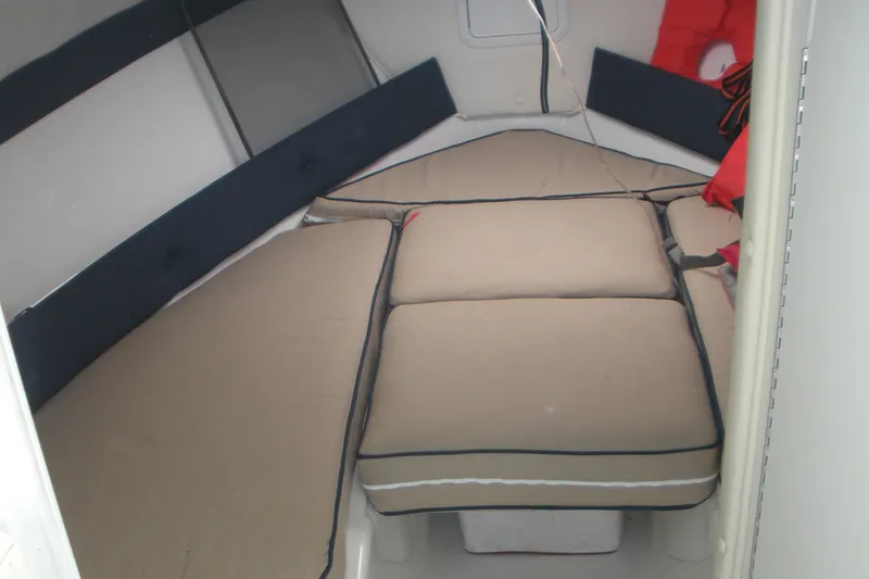 Slide: The Image of 2006 Baha Cruisers 277 GLE cabin interior with beige cushions and life jackets. - 6