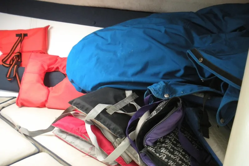 Slide: The Image of Life jackets and gear inside a 2006 Baha Cruisers 277 GLE boat cabin. - 7