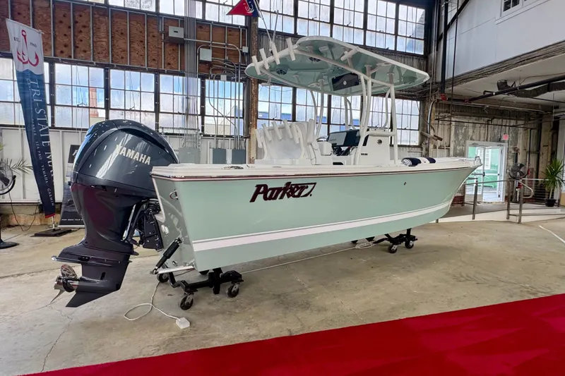 The Image of 2026 Parker 230 Coastal Elite boat with Yamaha engine displayed indoors. - 0
