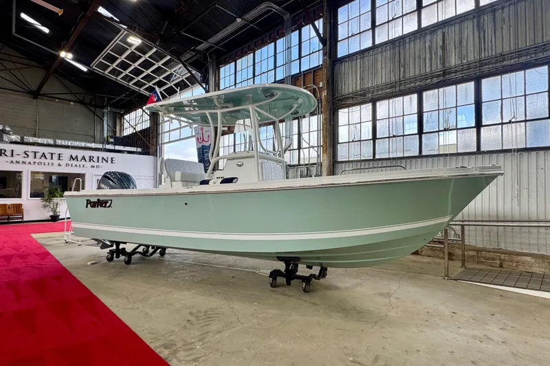 Slide: The Image of 2026 Parker 230 Coastal Elite boat displayed indoors at Tri-State Marine. - 2