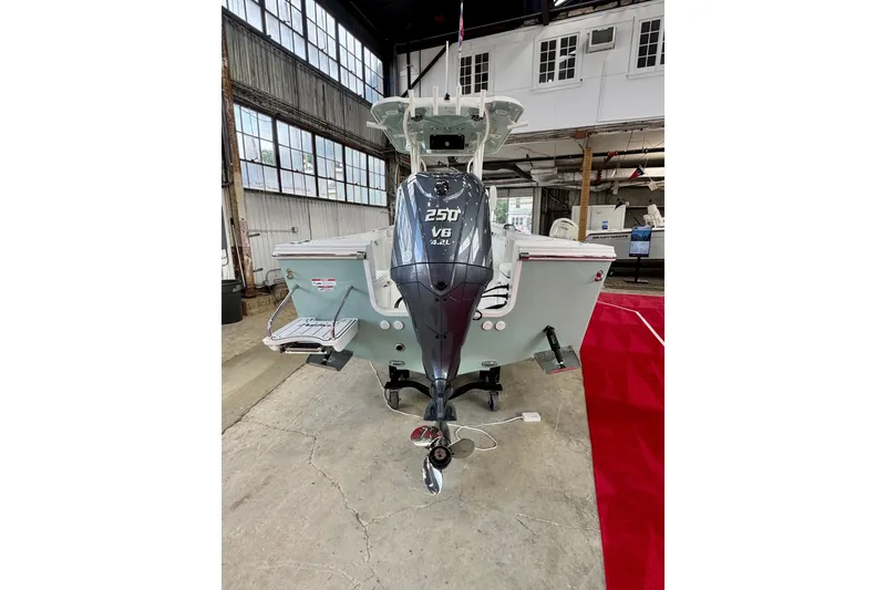 Slide: The Image of 2026 Parker 230 Coastal Elite boat with powerful V6 engine in a showroom. - 3