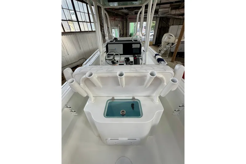 Slide: The Image of 2026 Parker 230 Coastal Elite boat interior with rod holders and control panel. - 4