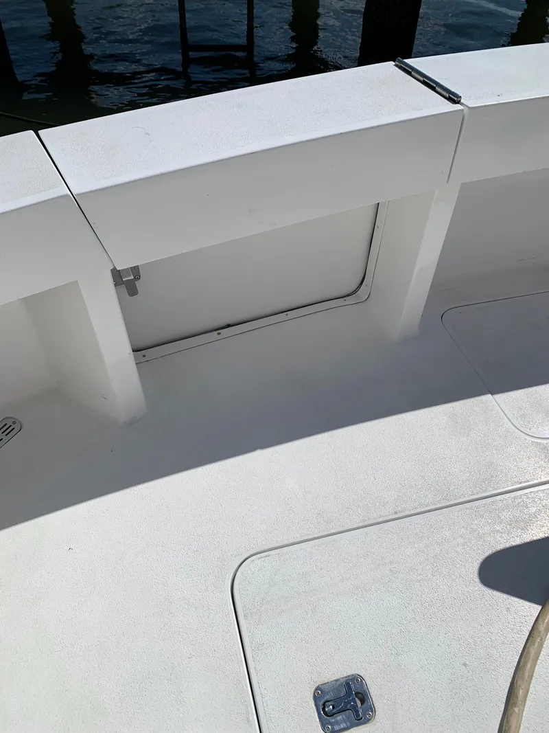 Slide: The Image of 2000 Viking 50 Convertible boat deck with storage compartment, docked by the water. - 10