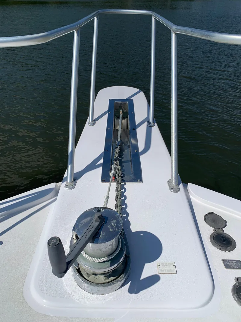 Slide: The Image of Bow of 2000 Viking 50 Convertible yacht with anchor winch and railing. - 16