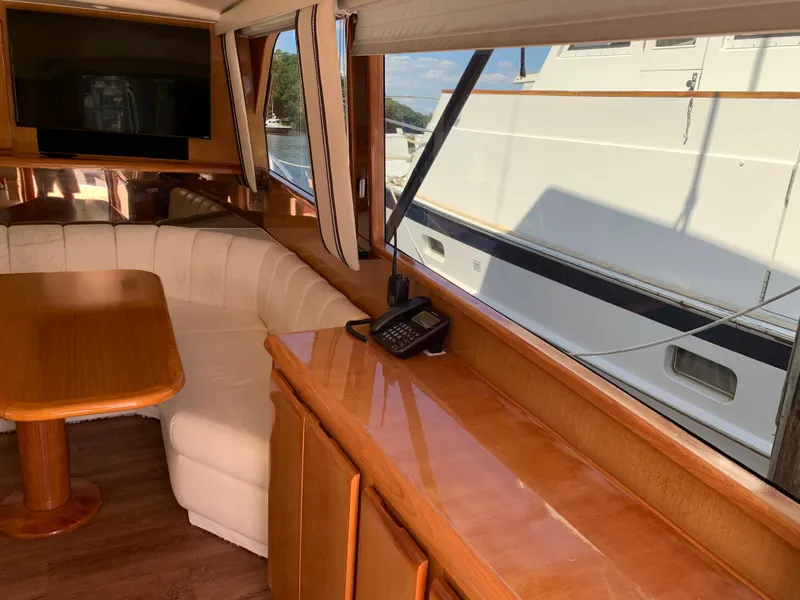 Slide: The Image of Interior of 2000 Viking 50 Convertible yacht with wood cabinetry and white seating. - 21