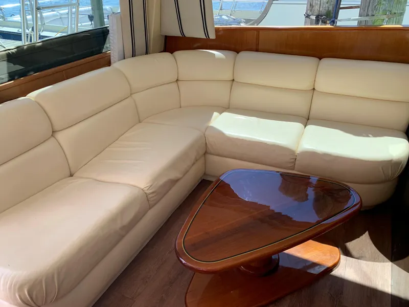 Slide: The Image of Luxurious cream leather sofa and wooden table in 2000 Viking 50 Convertible yacht interior. - 22