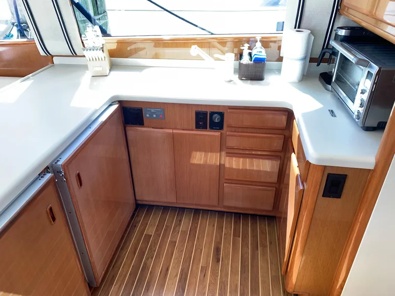 Slide: The Image of 2000 Viking 50 Convertible yacht kitchen with wood cabinets and modern appliances. - 23