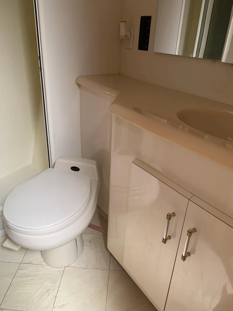Slide: The Image of Bathroom interior of a 2000 Viking 50 Convertible yacht with toilet and vanity. - 35
