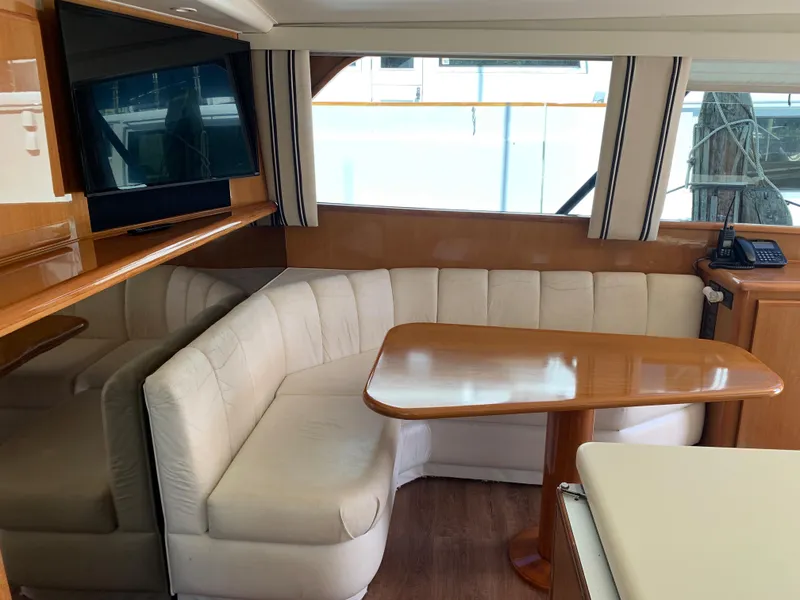 Slide: The Image of Luxurious interior of a 2000 Viking 50 Convertible yacht with plush seating and wooden table. - 39