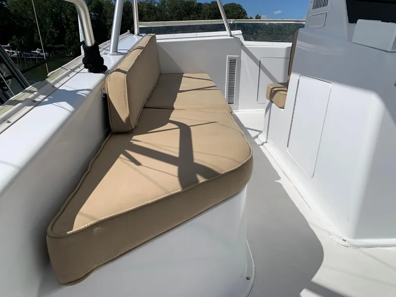 Slide: The Image of Beige cushioned seating on 2000 Viking 50 Convertible yacht deck, under clear blue sky. - 43