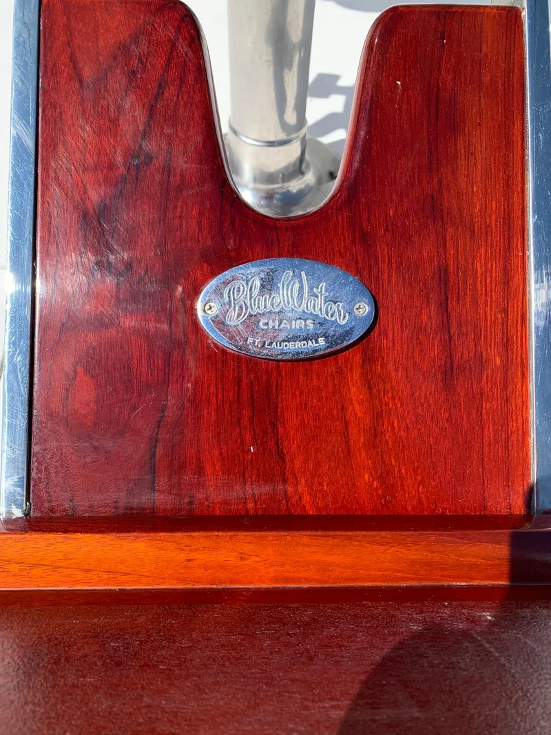 Slide: The Image of Close-up of a Viking 50 Convertible 2000 boat's wooden detail with a metal plaque. - 9