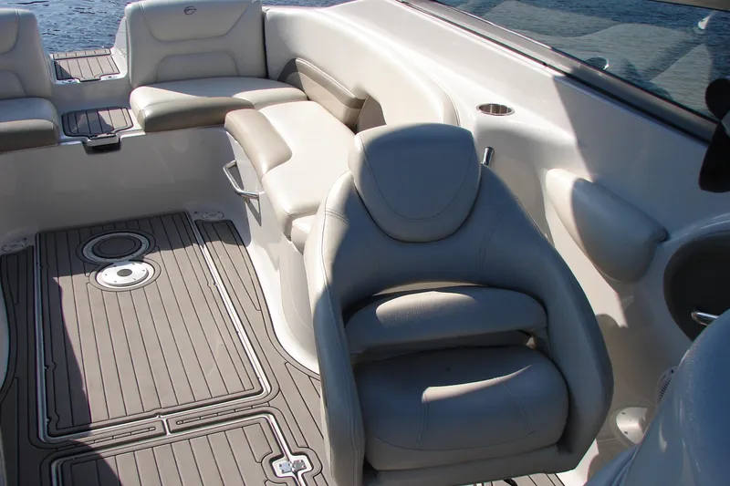 Slide: The Image of 2008 Crownline 270 BR boat interior with beige seating and textured flooring. - 12