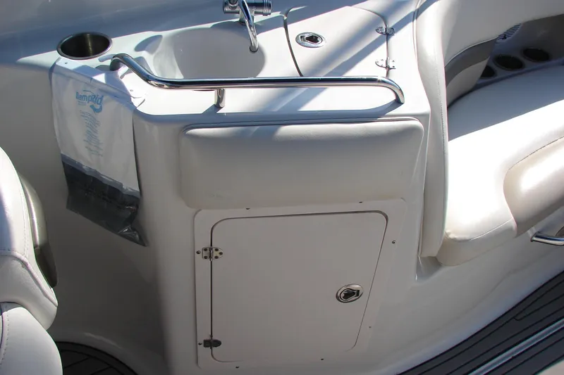Slide: The Image of 2008 Crownline 270 BR boat interior with sink and storage compartment. - 15
