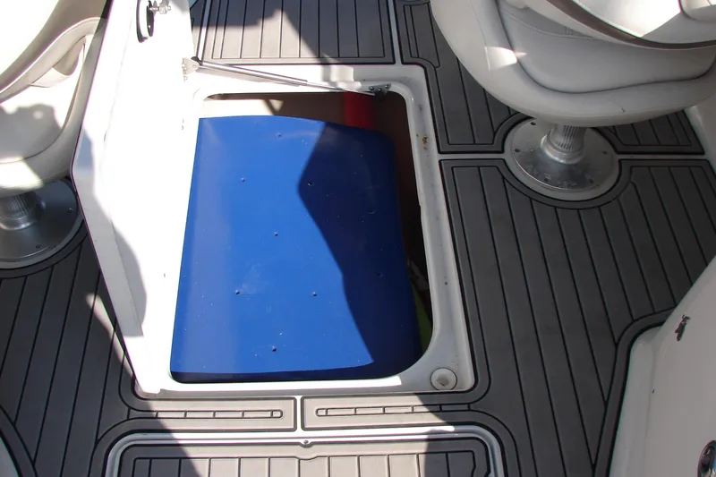 Slide: The Image of Open storage compartment on 2008 Crownline 270 BR boat with blue interior. - 16