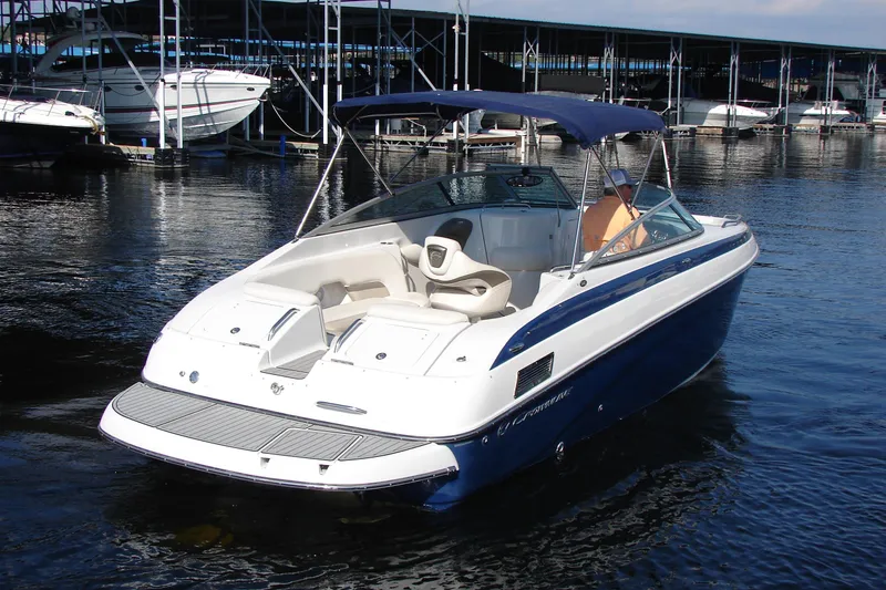 Slide: The Image of 2008 Crownline 270 BR boat docked in marina, featuring sleek design and blue accents. - 2