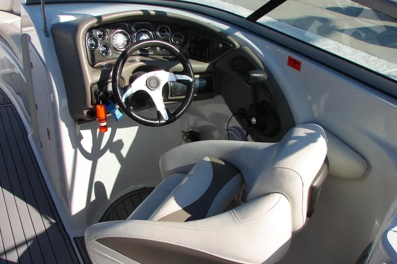 Slide: The Image of 2008 Crownline 270 BR boat cockpit with steering wheel and control panel. - 20