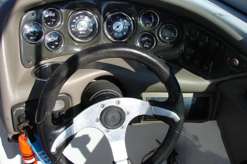 Slide: The Image of Dashboard of a 2008 Crownline 270 BR boat with steering wheel and gauges. - 21