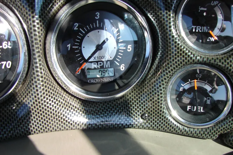 Slide: The Image of Dashboard gauges of a 2008 Crownline 270 BR boat, showing RPM, trim, and fuel levels. - 22