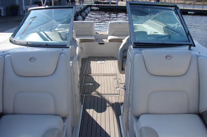 Slide: The Image of 2008 Crownline 270 BR boat interior with white seating and open deck layout. - 25