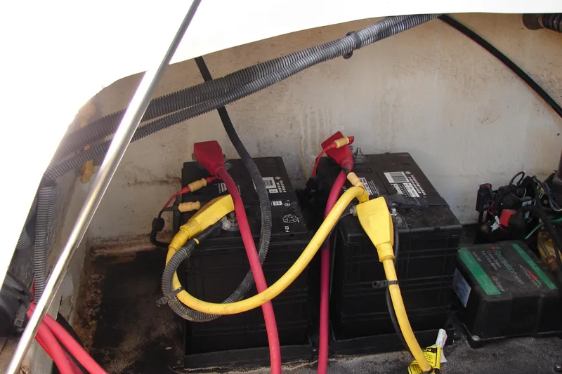 Slide: The Image of Battery compartment of a 2008 Crownline 270 BR boat with cables and connectors. - 28
