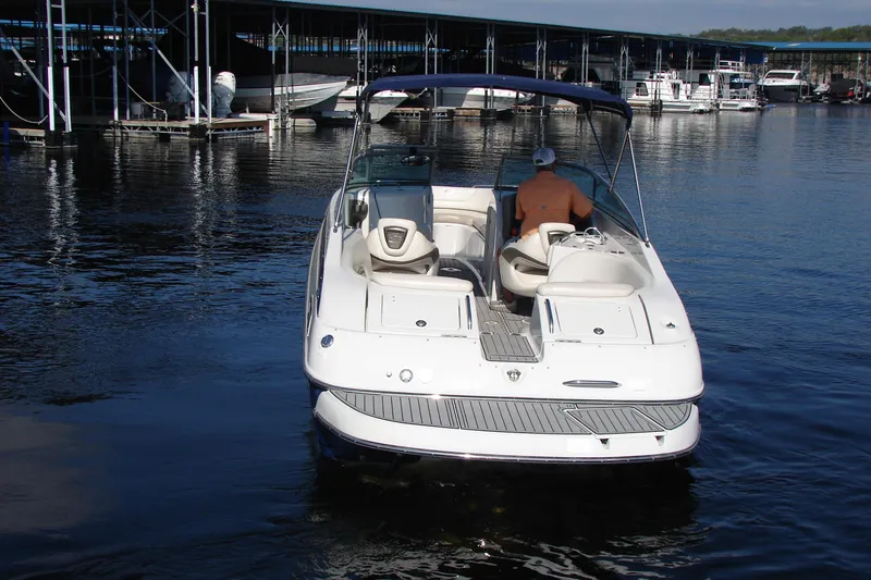 Slide: The Image of 2008 Crownline 270 BR boat docked at marina, rear view with canopy. - 3