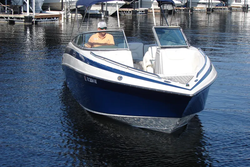Slide: The Image of 2008 Crownline 270 BR boat on water, featuring sleek design and blue hull. - 9