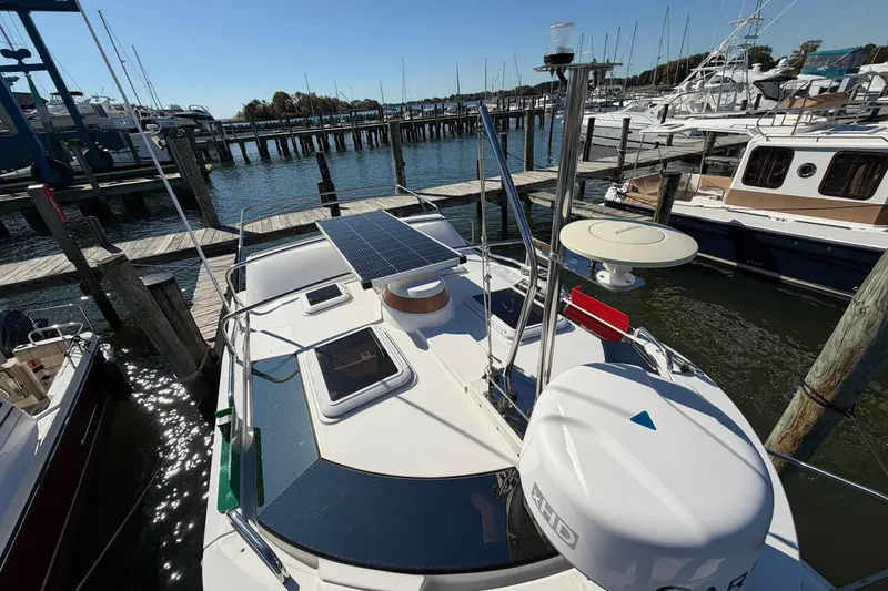Slide: The Image of 2023 Ranger Tugs R-25 boat docked, featuring solar panels and navigation equipment. - 13