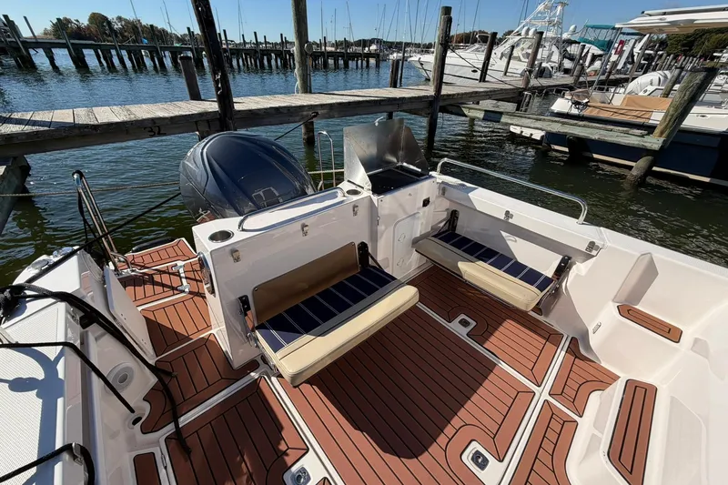 Slide: The Image of 2023 Ranger Tugs R-25 boat interior with seating, docked at marina. - 22