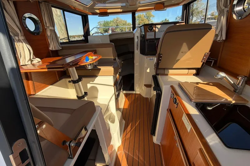 Slide: The Image of Interior of 2023 Ranger Tugs R-25 boat, featuring wood accents and modern amenities. - 27
