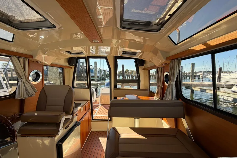Slide: The Image of Interior of 2023 Ranger Tugs R-25 boat with elegant seating and panoramic windows. - 30