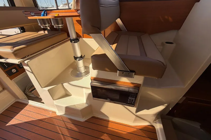 Slide: The Image of Interior of 2023 Ranger Tugs R-25 boat with seating and wooden flooring. - 35