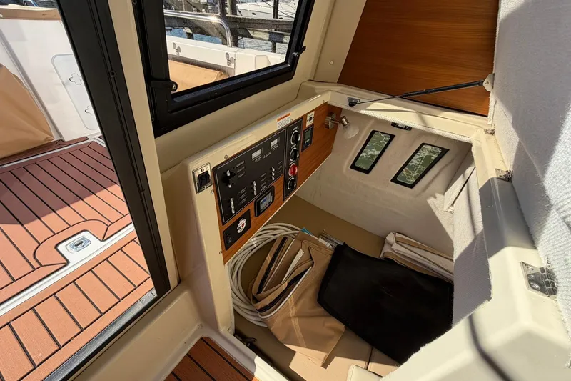 Slide: The Image of 2023 Ranger Tugs R-25 interior with control panel and wooden flooring. - 37