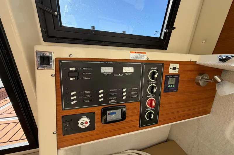 Slide: The Image of Control panel of 2023 Ranger Tugs R-25 boat, featuring switches and gauges. - 38