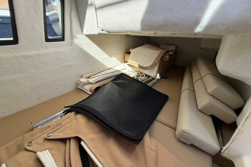 Slide: The Image of Interior cabin of 2023 Ranger Tugs R-25 with beige upholstery and storage items. - 40