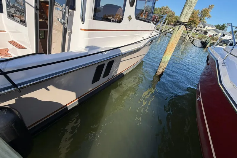 Slide: The Image of 2023 Ranger Tugs R-25 docked, showcasing sleek design and modern features. - 5