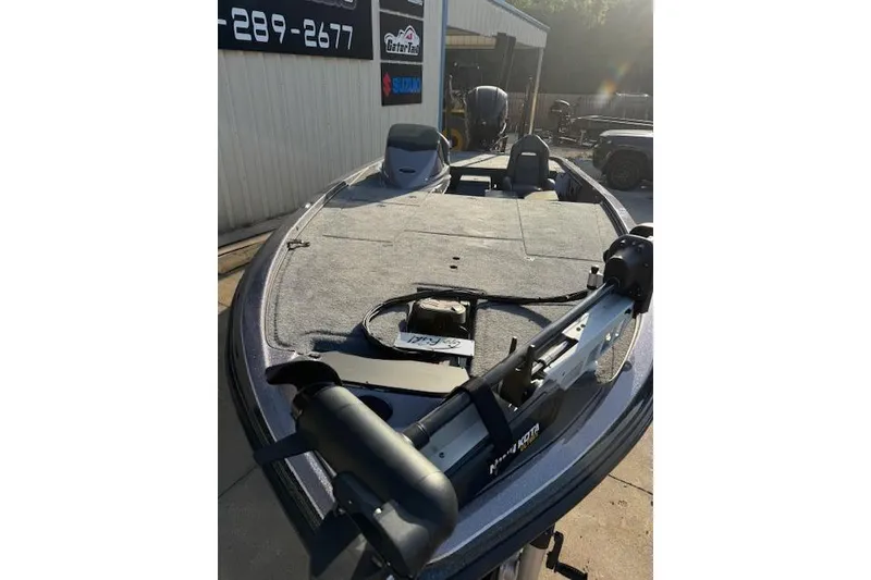 Slide: The Image of 2025 Falcon Boats F21 Predator, sleek design, parked outdoors, featuring advanced fishing equipment. - 6