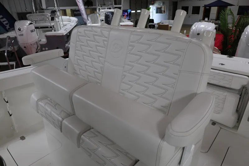 Slide: The Image of 2026 Parker 274 Fathom boat interior with luxurious white seating and armrests. - 11
