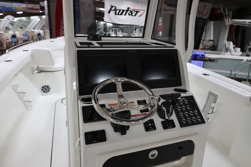 Slide: The Image of 2026 Parker 274 Fathom boat dashboard with steering wheel and control panel. - 12