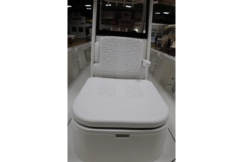 Slide: The Image of 2026 Parker 274 Fathom boat seat with white cushioned design in showroom setting. - 14