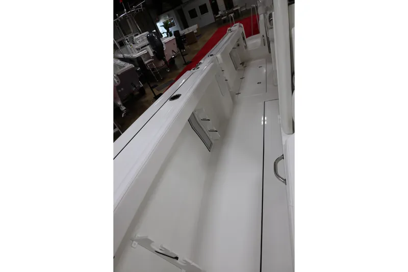 Slide: The Image of 2026 Parker 274 Fathom boat interior, showcasing sleek white deck and storage compartments. - 16