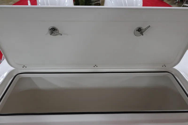 Slide: The Image of Open storage compartment on 2026 Parker 274 Fathom boat, featuring secure latches. - 18