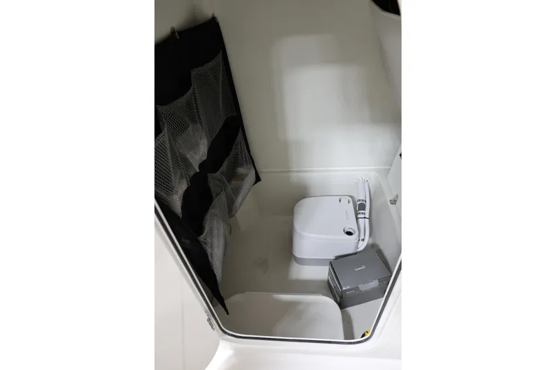 Slide: The Image of Interior of 2026 Parker 274 Fathom boat featuring compact toilet and storage area. - 21