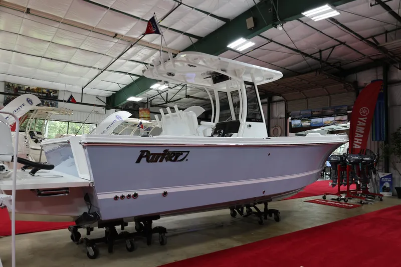 Slide: The Image of 2026 Parker 274 Fathom boat displayed indoors on red carpet. - 22