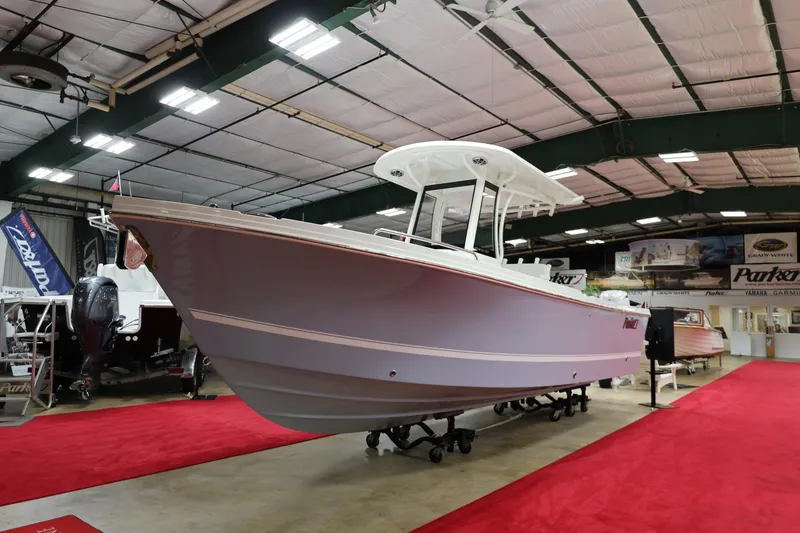 Slide: The Image of 2026 Parker 274 Fathom boat displayed in showroom with red carpet. - 3