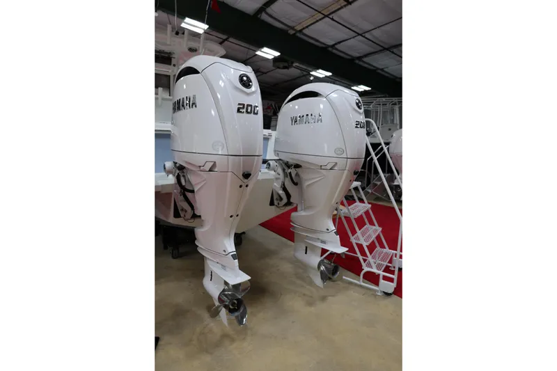 Slide: The Image of Twin Yamaha 200 outboard engines on a 2026 Parker 274 Fathom boat in a showroom. - 5