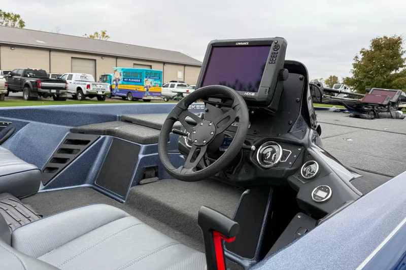Slide: The Image of 2022 Skeeter ZXR21 boat dashboard with steering wheel and navigation display. - 11
